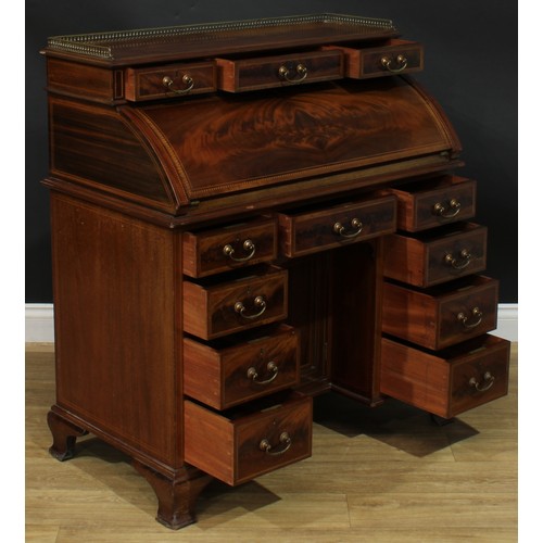 1334 - A late Victorian mahogany barrel-top kneehole desk, by Cooper & Holt (fl.1862-1889), badged, brass t... 