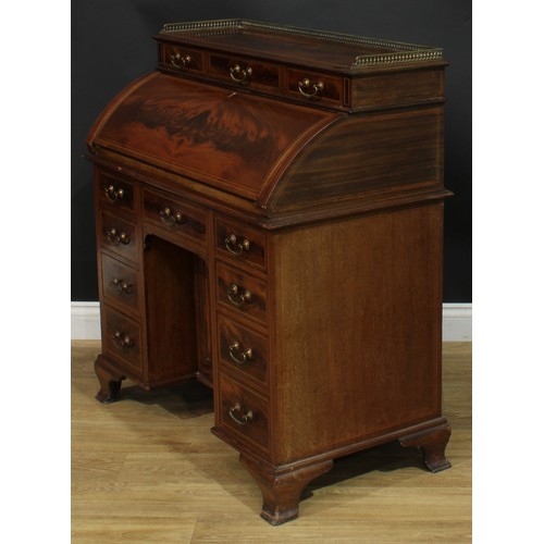 1334 - A late Victorian mahogany barrel-top kneehole desk, by Cooper & Holt (fl.1862-1889), badged, brass t... 