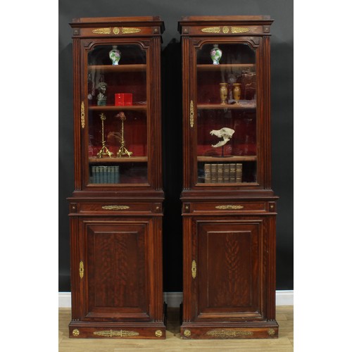 1372 - A pair of 19th century French Empire design gilt metal mounted mahogany pier bookcases, each with an... 