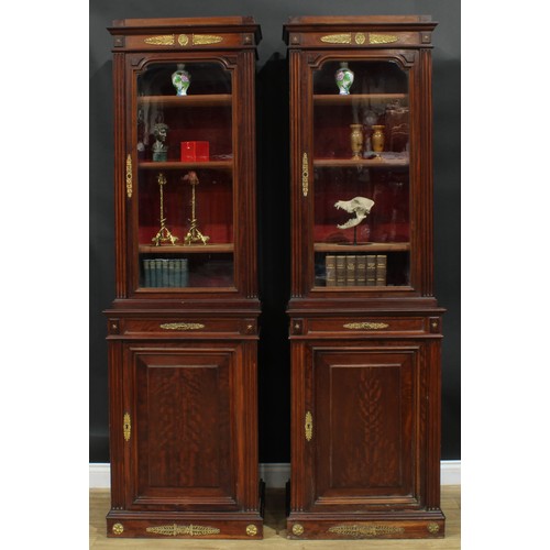 1372 - A pair of 19th century French Empire design gilt metal mounted mahogany pier bookcases, each with an... 