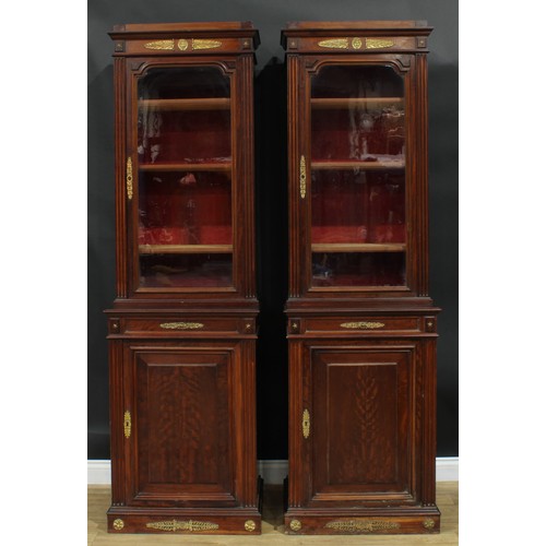 1372 - A pair of 19th century French Empire design gilt metal mounted mahogany pier bookcases, each with an... 