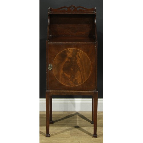 1172 - A George III Revival mahogany bedroom cabinet, shaped and pierced back above a fiddleback and flame ... 