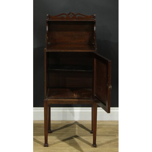 1172 - A George III Revival mahogany bedroom cabinet, shaped and pierced back above a fiddleback and flame ... 