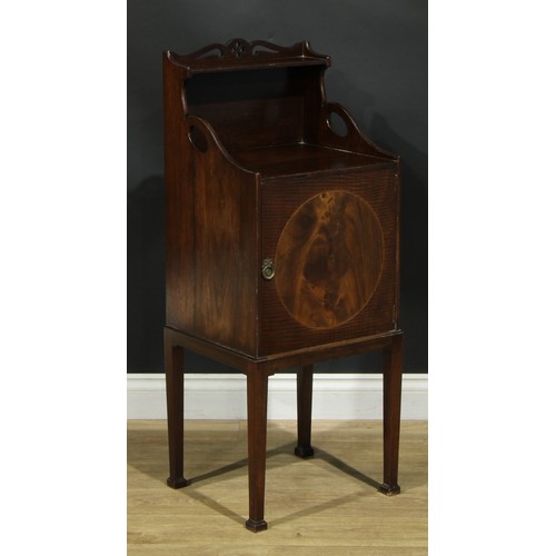 1172 - A George III Revival mahogany bedroom cabinet, shaped and pierced back above a fiddleback and flame ... 