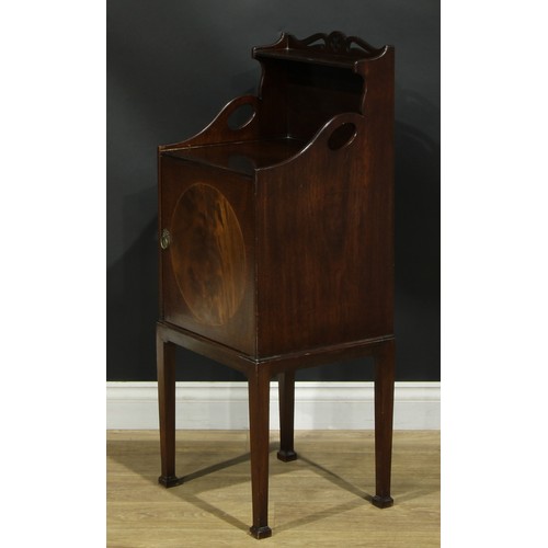 1172 - A George III Revival mahogany bedroom cabinet, shaped and pierced back above a fiddleback and flame ... 