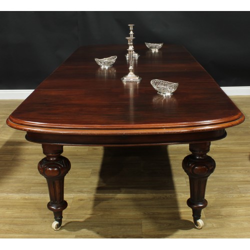 1292 - A large Victorian mahogany five-leg extending dining table, discorectangular top with three addition... 