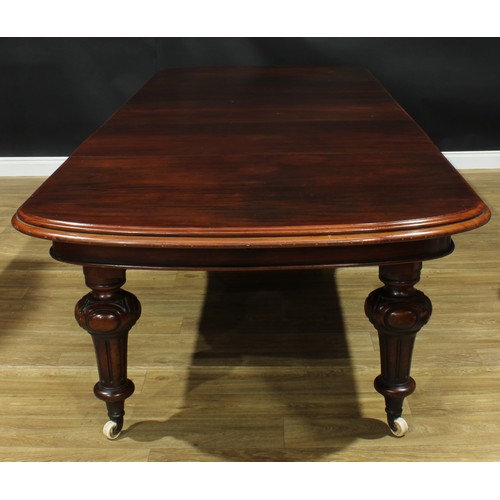 1292 - A large Victorian mahogany five-leg extending dining table, discorectangular top with three addition... 