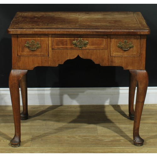 1100 - A George II walnut lowboy, crossbanded quarter-veneered top above three frieze drawers, shaped apron... 