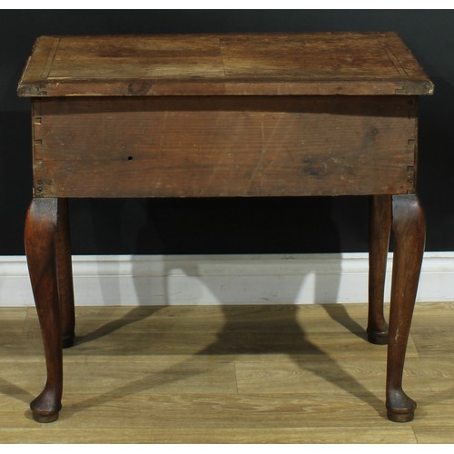 1100 - A George II walnut lowboy, crossbanded quarter-veneered top above three frieze drawers, shaped apron... 