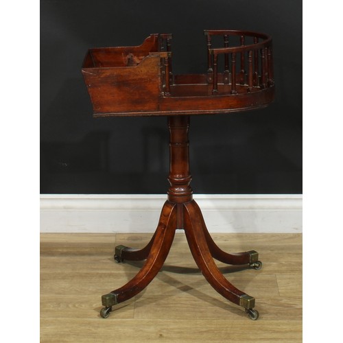 1432 - A Regency mahogany revolving butler’s plate and cutlery stand, turned column, sabre legs, brass capp... 