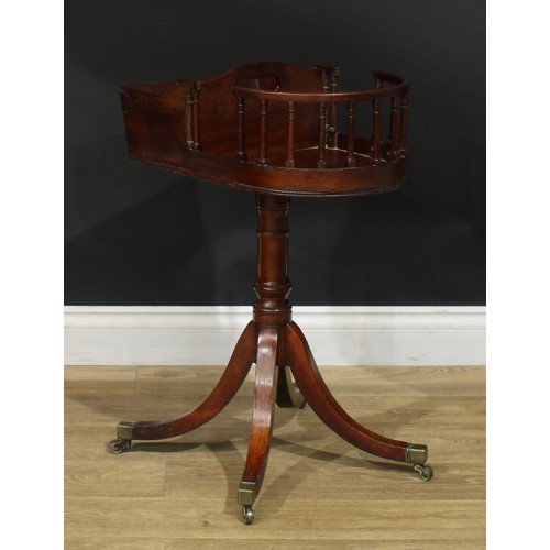 1432 - A Regency mahogany revolving butler’s plate and cutlery stand, turned column, sabre legs, brass capp... 