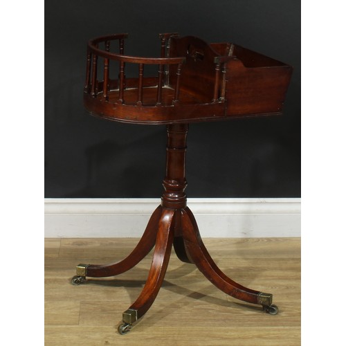 1432 - A Regency mahogany revolving butler’s plate and cutlery stand, turned column, sabre legs, brass capp... 