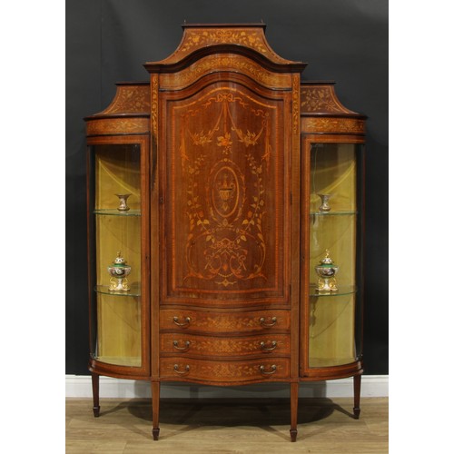 1136 - A Sheraton Revival satinwood banded mahogany and marquetry display cabinet, caddy top above a serpen... 