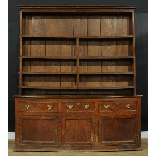 1286 - A large George III ash and elm country house dresser, outswept cornice above four plate rack shelves... 