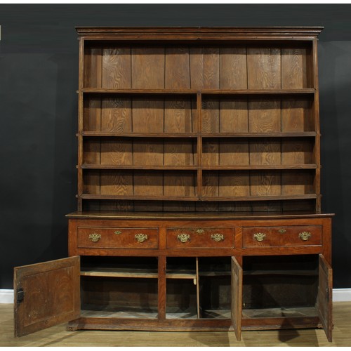 1286 - A large George III ash and elm country house dresser, outswept cornice above four plate rack shelves... 