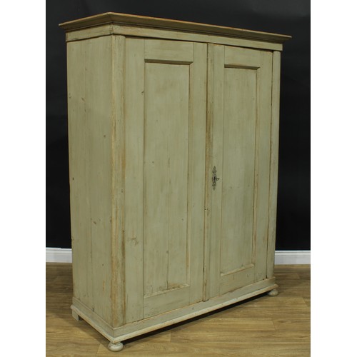 1058 - A French Provincial design painted pine armoire, outswept cornice above a pair of panel doors, skirt... 