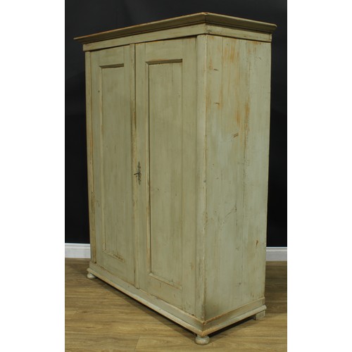 1058 - A French Provincial design painted pine armoire, outswept cornice above a pair of panel doors, skirt... 