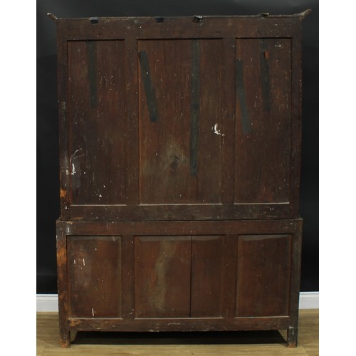 1270 - A George III oak housekeeper’s livery or provision cupboard, moulded cornice above a pair of panel d... 