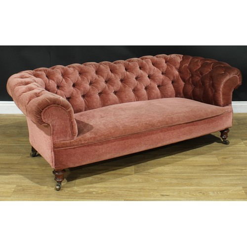 1458 - A Victorian Chesterfield sofa, stuffed-over upholstery, deep-button back, scroll arms, turned forele... 