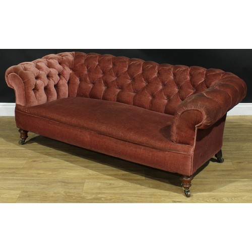 1458 - A Victorian Chesterfield sofa, stuffed-over upholstery, deep-button back, scroll arms, turned forele... 