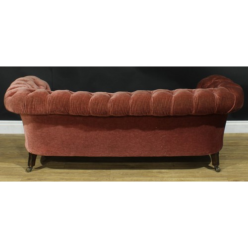 1458 - A Victorian Chesterfield sofa, stuffed-over upholstery, deep-button back, scroll arms, turned forele... 