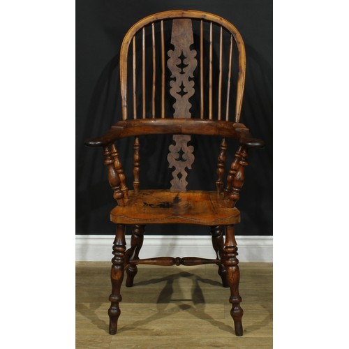 1369 - A near set of four 19th century Yorkshire yew and elm Windsor elbow chairs, each with a hoop back, s... 