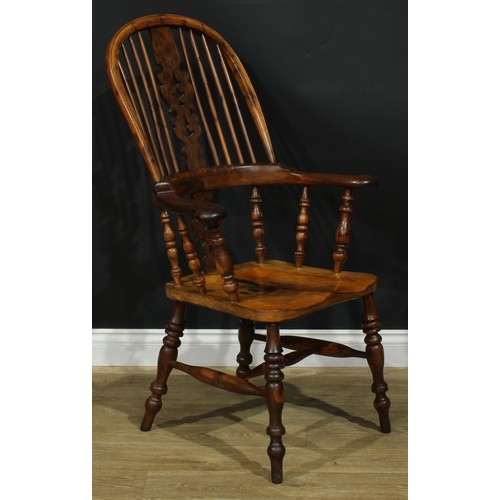 1369 - A near set of four 19th century Yorkshire yew and elm Windsor elbow chairs, each with a hoop back, s... 