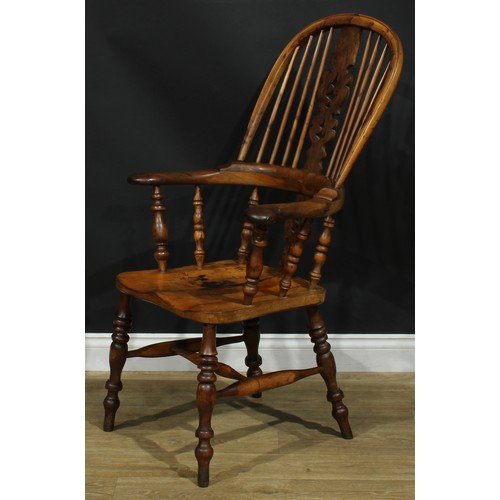 1369 - A near set of four 19th century Yorkshire yew and elm Windsor elbow chairs, each with a hoop back, s... 