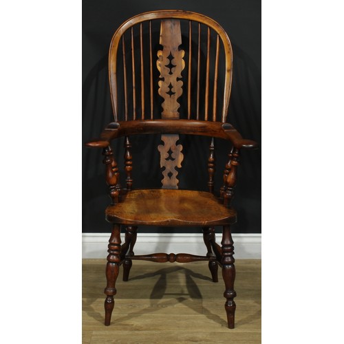 1369 - A near set of four 19th century Yorkshire yew and elm Windsor elbow chairs, each with a hoop back, s... 