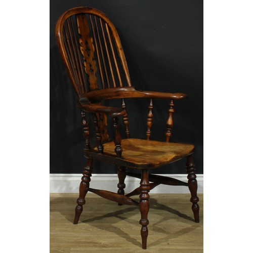 1369 - A near set of four 19th century Yorkshire yew and elm Windsor elbow chairs, each with a hoop back, s... 