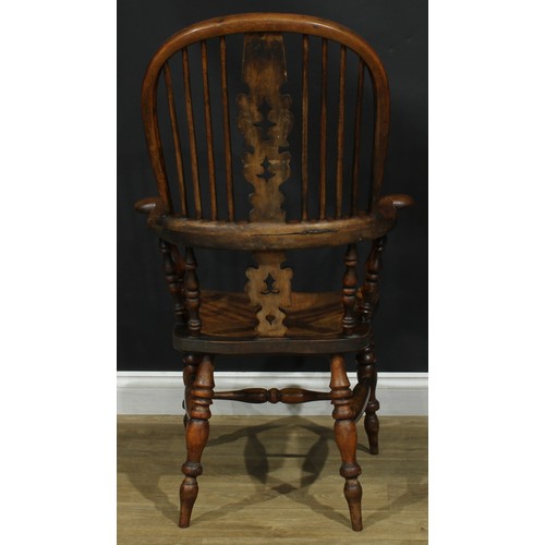 1369 - A near set of four 19th century Yorkshire yew and elm Windsor elbow chairs, each with a hoop back, s... 