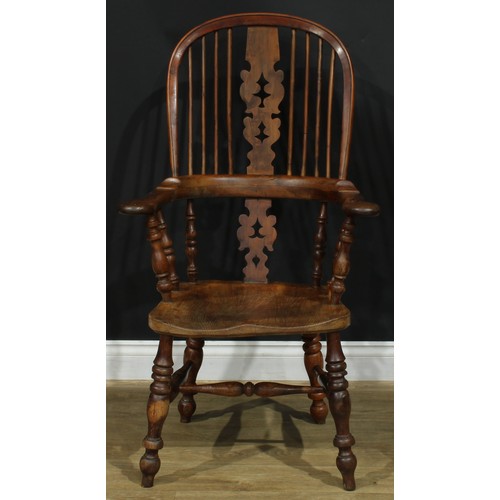 1369 - A near set of four 19th century Yorkshire yew and elm Windsor elbow chairs, each with a hoop back, s... 