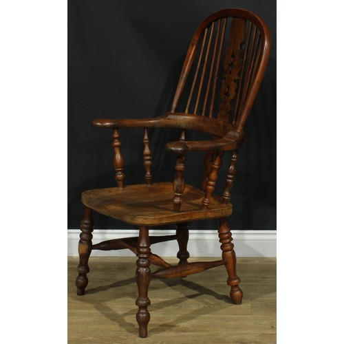 1369 - A near set of four 19th century Yorkshire yew and elm Windsor elbow chairs, each with a hoop back, s... 