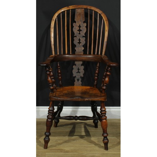 1369 - A near set of four 19th century Yorkshire yew and elm Windsor elbow chairs, each with a hoop back, s... 