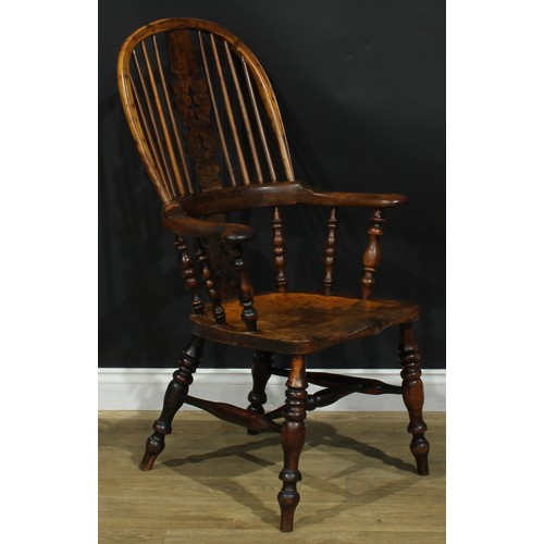 1369 - A near set of four 19th century Yorkshire yew and elm Windsor elbow chairs, each with a hoop back, s... 