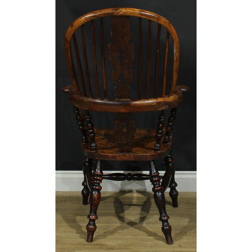 1369 - A near set of four 19th century Yorkshire yew and elm Windsor elbow chairs, each with a hoop back, s... 