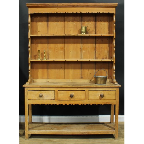 991 - A 19th century pine potboard dresser, moulded cornice above two plate racks, the projecting base wit... 