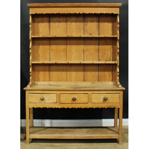 991 - A 19th century pine potboard dresser, moulded cornice above two plate racks, the projecting base wit... 