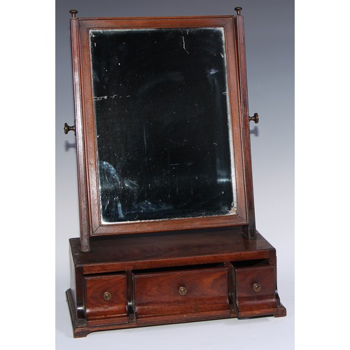 1218 - A George III mahogany dressing glass, rectangular mirror plate, the base with three drawers, shallow... 