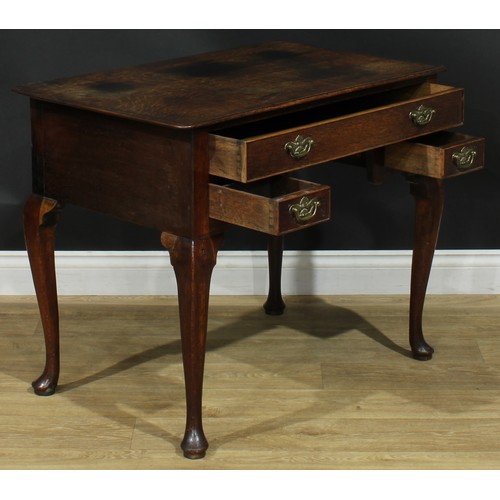 1163 - A George III oak lowboy or side table, rectangular top above one long and two small cockbeaded drawe... 