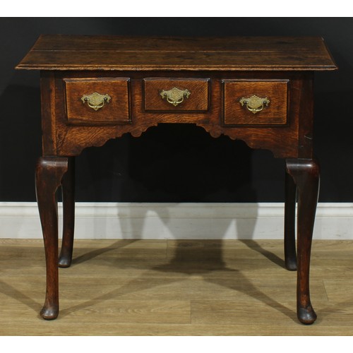 1164 - A George III oak lowboy or side table, rectangular top above three drawers, shaped apron, cabriole l... 