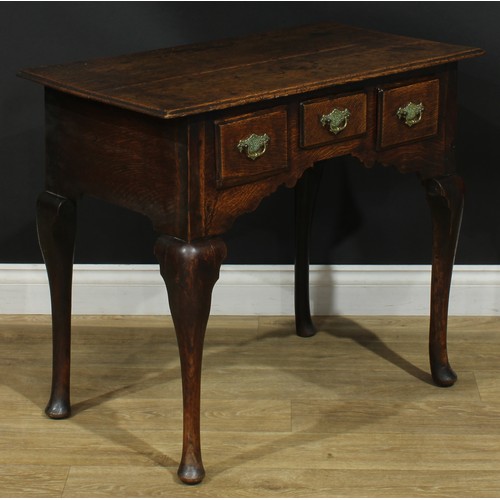 1164 - A George III oak lowboy or side table, rectangular top above three drawers, shaped apron, cabriole l... 