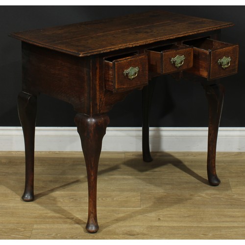 1164 - A George III oak lowboy or side table, rectangular top above three drawers, shaped apron, cabriole l... 