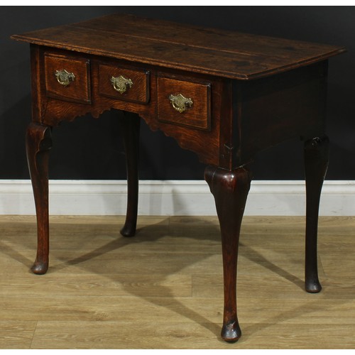 1164 - A George III oak lowboy or side table, rectangular top above three drawers, shaped apron, cabriole l... 