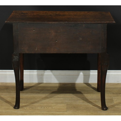 1164 - A George III oak lowboy or side table, rectangular top above three drawers, shaped apron, cabriole l... 