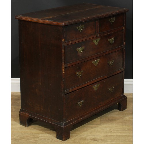 1089 - A George I/II oak chest, of small proportions, slightly oversailing top above two short and three lo... 