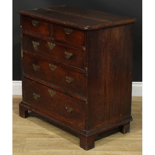 1089 - A George I/II oak chest, of small proportions, slightly oversailing top above two short and three lo... 