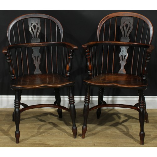 1374 - A pair of 19th century yew, elm and ash Windsor elbow chairs, each with a low hoop back, shaped and ... 