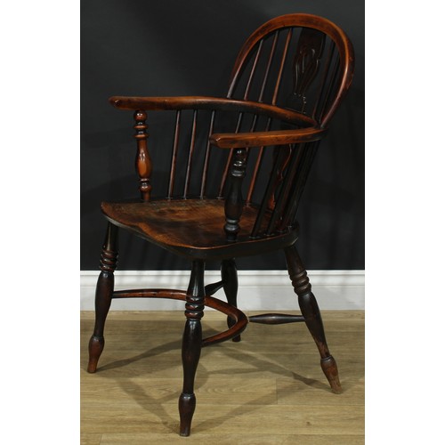 1374 - A pair of 19th century yew, elm and ash Windsor elbow chairs, each with a low hoop back, shaped and ... 