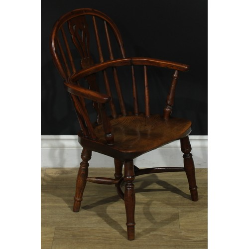 1009 - A 19th century yew and elm miniature Windsor elbow chair, hoop back, shaped and pierced splat, turne... 